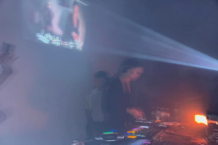 dj decks in warehouse fog and lasers